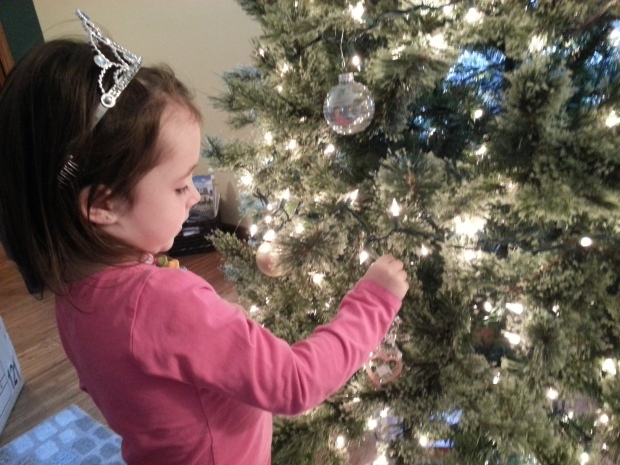 Brenna hanging an ornament (a non-fragile one, of course)...